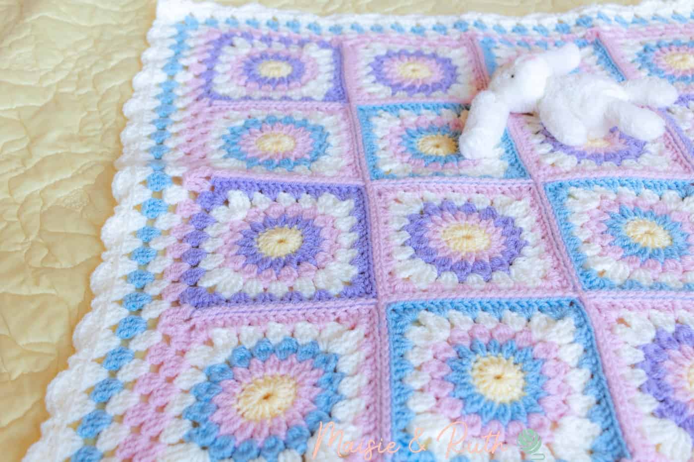 Crochet Sunburst Granny Square Blanket on Bed