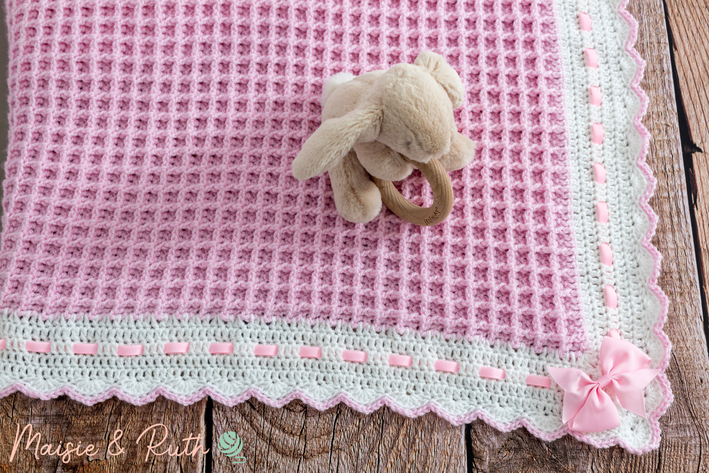 Crochet Waffle Stitch Baby Blanket On Wood with Bunny
