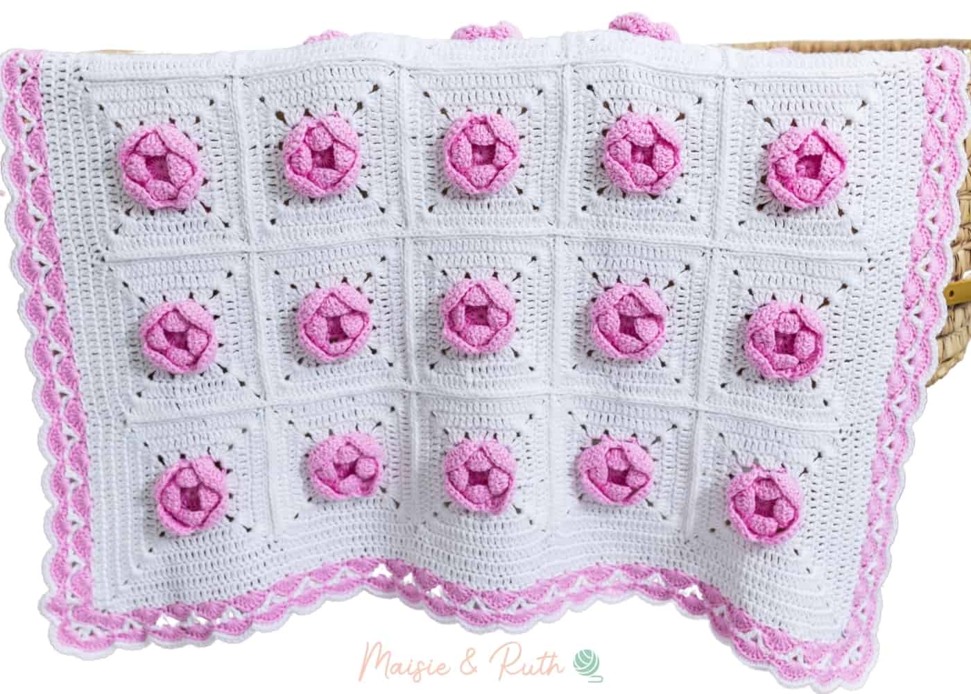 Crochet Rose Baby Blanket Hanging Over Basket