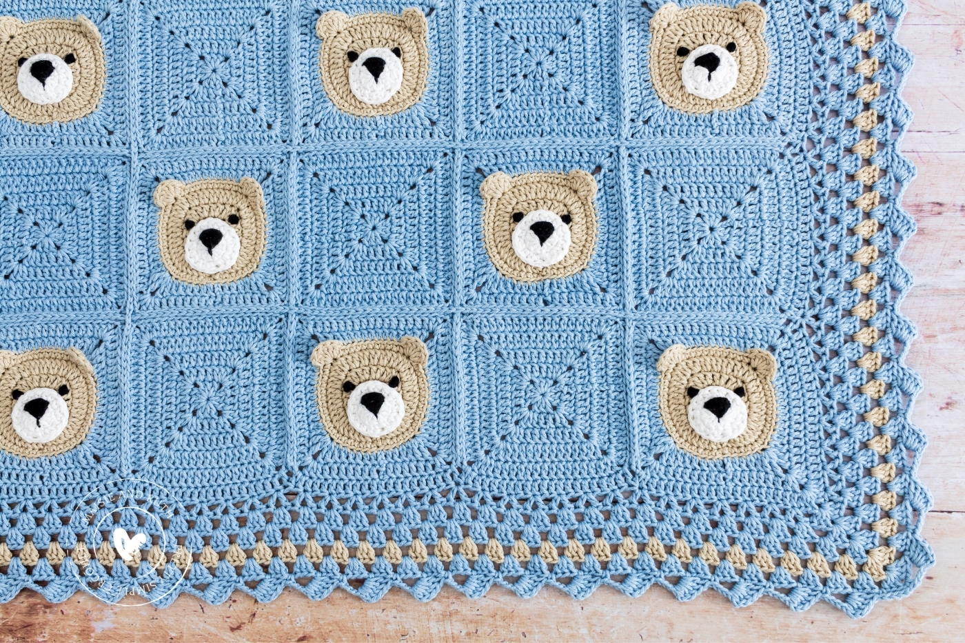 Bear Crochet Baby Blanket on light wood table