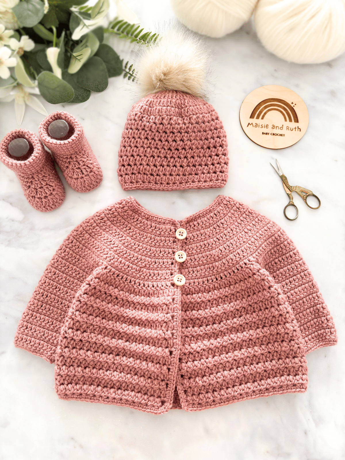 Crochet baby cardigan pattern with classic round yoke and long sleeves