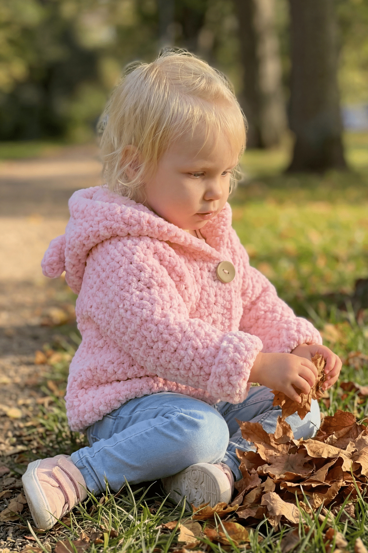 little girl wearing pink crochet jacket