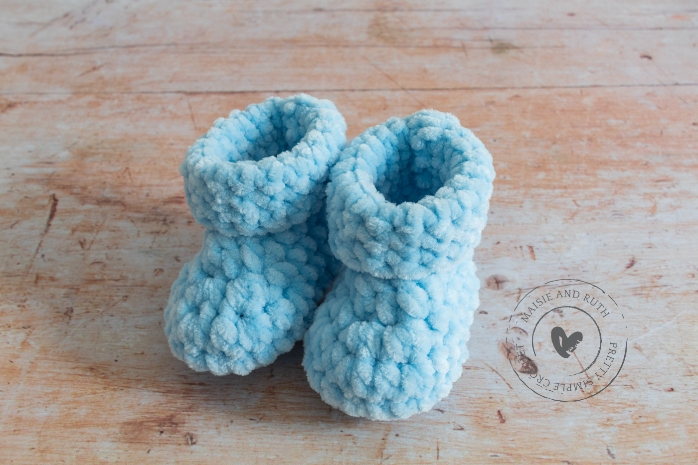 Chunky crochet baby booties side view of blue ones