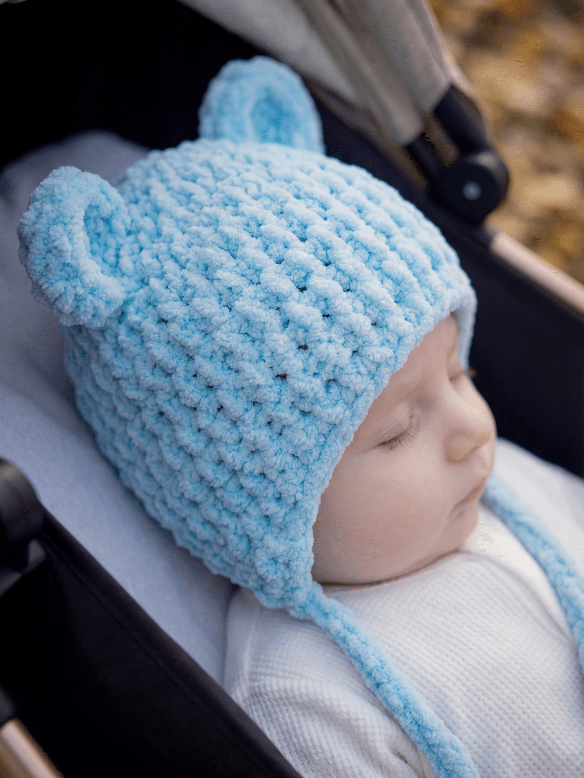 crochet baby bear beanie on baby's head outdoors