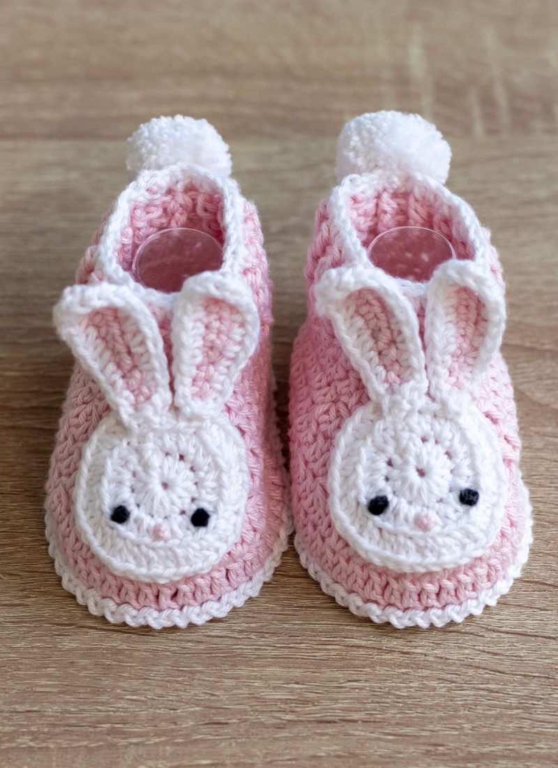 bunny crochet baby booties on table