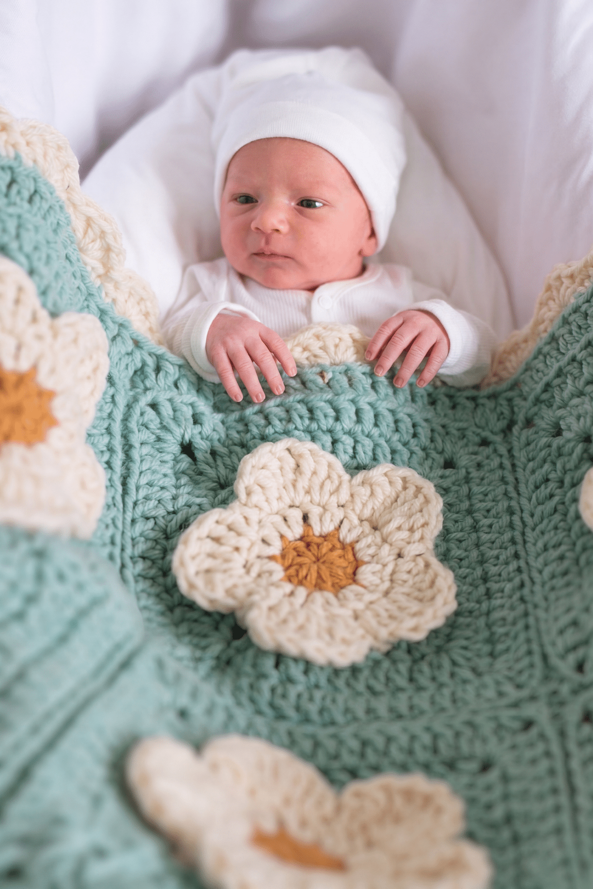 Vintage-inspired baby cozy petals blanket in Sea Glass with textured flowers